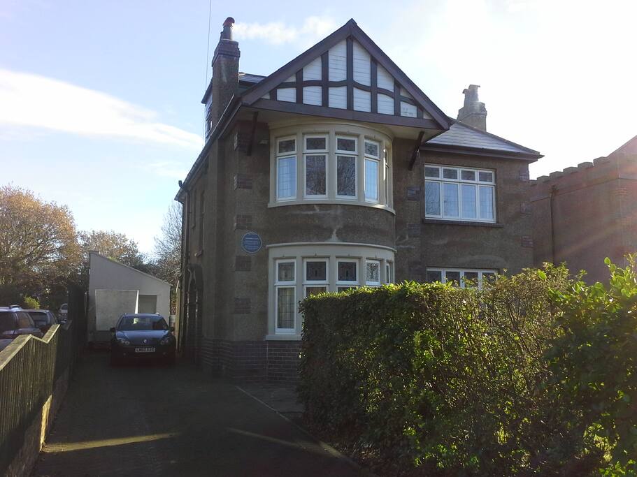 Front view of the house ( as seen from the main road) with its historical blue plaque commemorating an earlier resident, the Welsh poet and visionary John Saunders Lewis.
