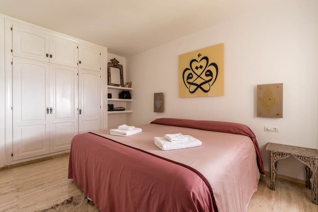 Bedroom with king size bed & bathroom