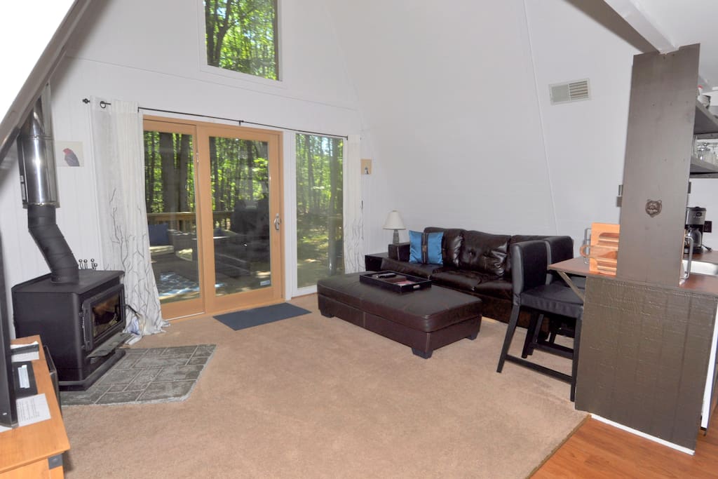 Kick back in the comfortable living area with wood burning stove. The large doors welcome in the warm, natural light.