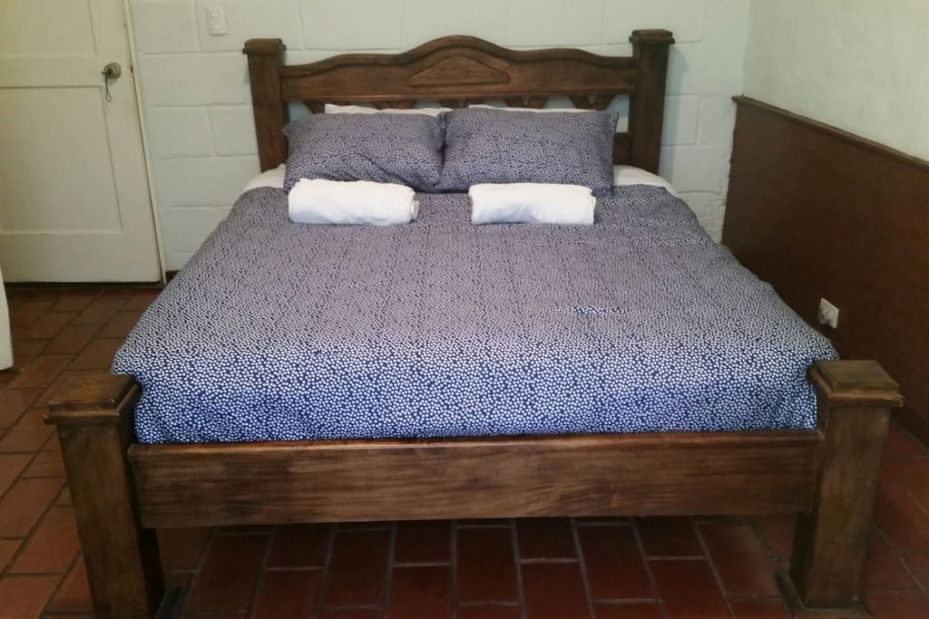 Comfy Queen bed with French doors to outside courtyard and private bath.