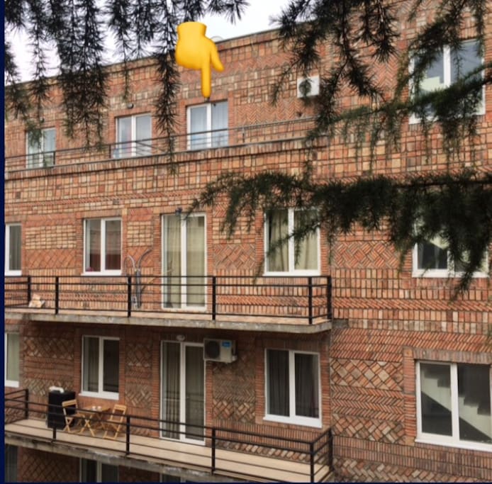 Yellow hand pointing to our door and terrace.
exterior of our house