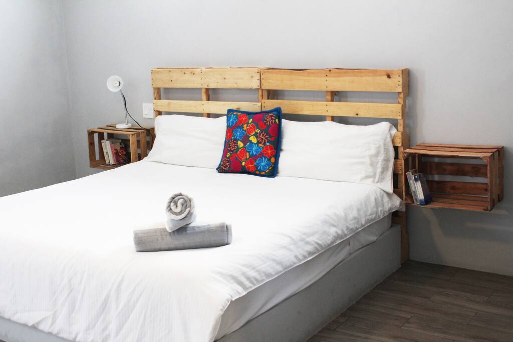 Spacious bedroom with fabulous king size bed, air conditioner, ceiling fan and closet