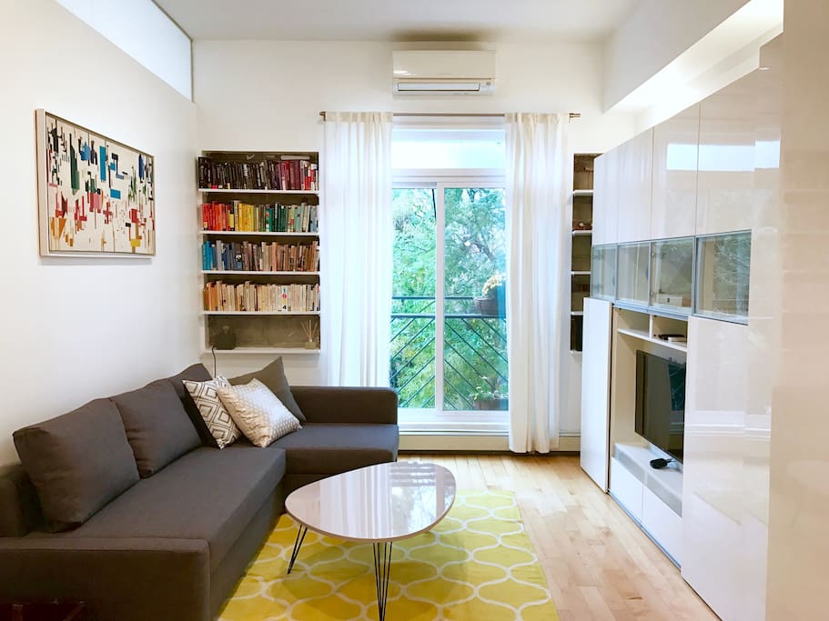 Light-filled living room overlooking quiet backyards