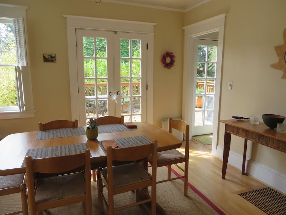 Light-filled dining room with french doors to deck.