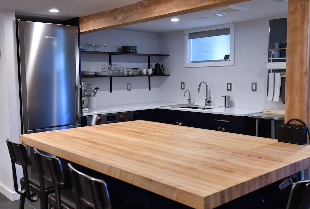 Large 4' x 6' maple Boos butcher block island for food prep and eating.