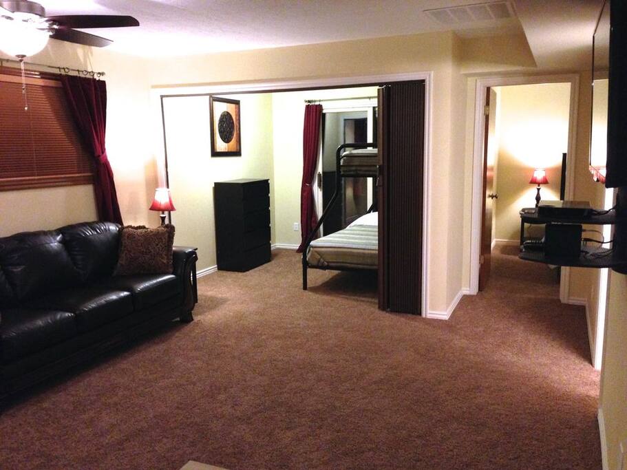 Living room, bunk room with accordion divider, and hallway to master bedroom.