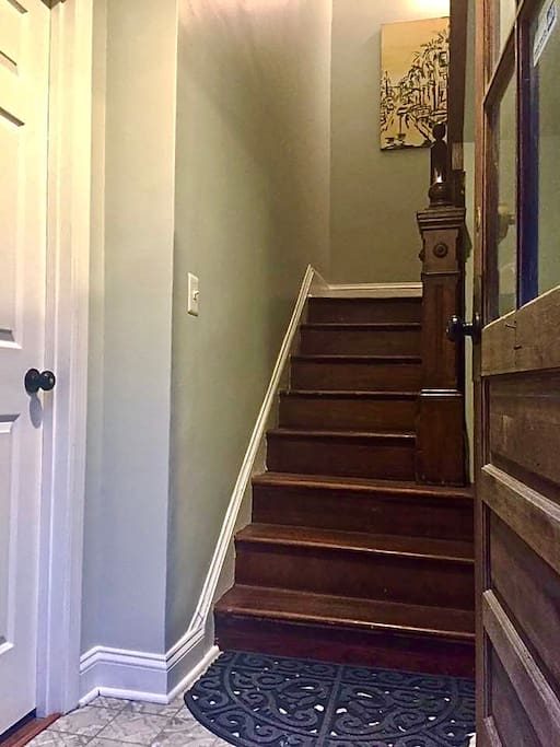 The original wood staircase leads you past gallery worthy original art and up to the top two floors.