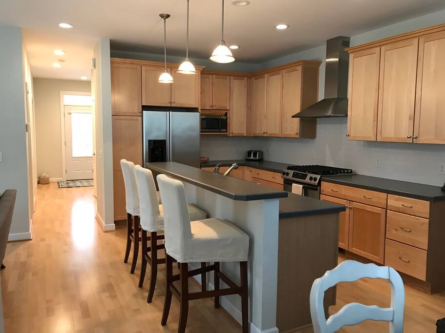 Kitchen with bar seating for 3 and dining table seats 8.