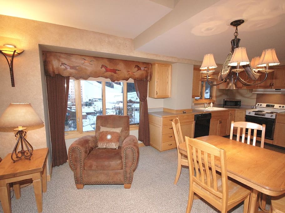 Window with expansive views of village and ski runs.