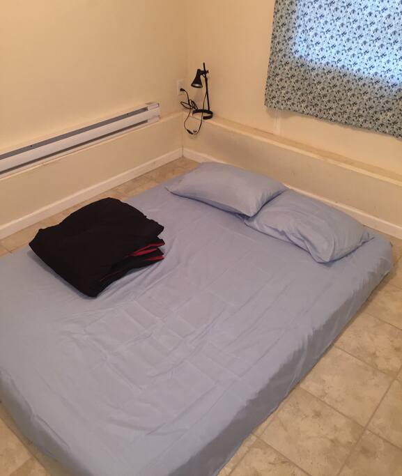 Bedroom: sheets and comforter are clean and floor is mopped