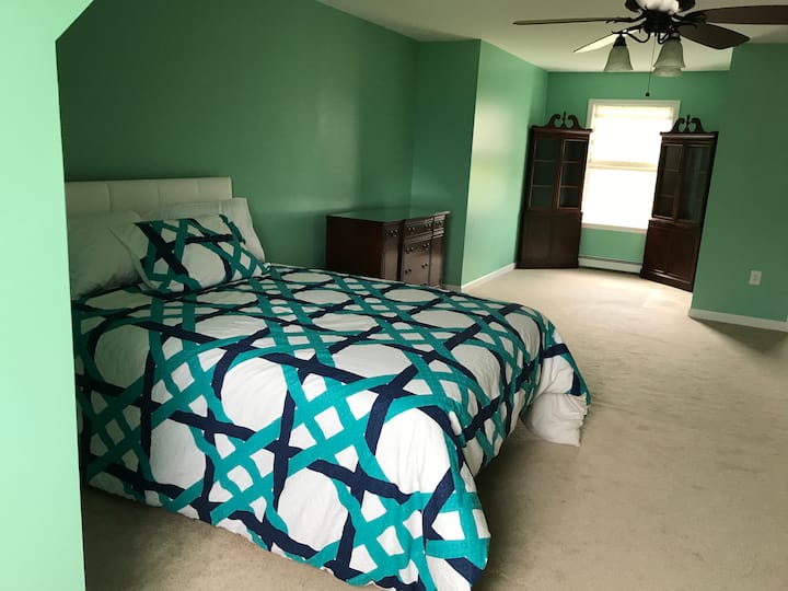 Very spacious second floor guestroom with queen bed and private bath.