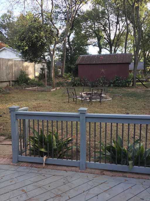 Large fenced in backyard with fire pit, outdoor table, and grill (shared space)