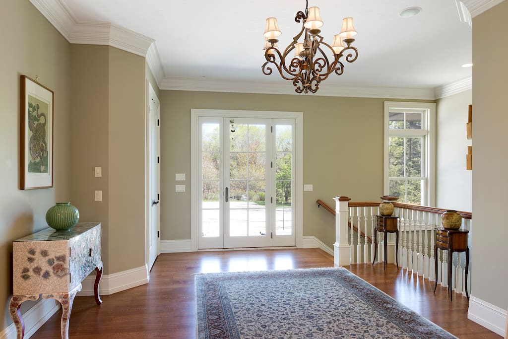 Bright, open foyer with hardwood floors and custom finishes.
