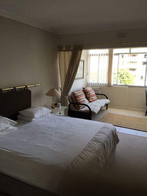 Bedroom and sun area, which includes work desk and sofa couch