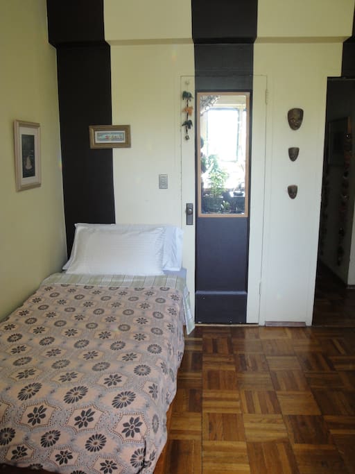 Sunny private room with single bed.