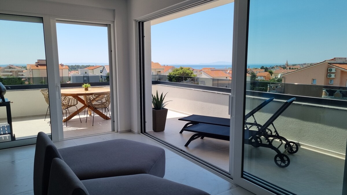 Spacious living area with a large terrace overlooking the sea 