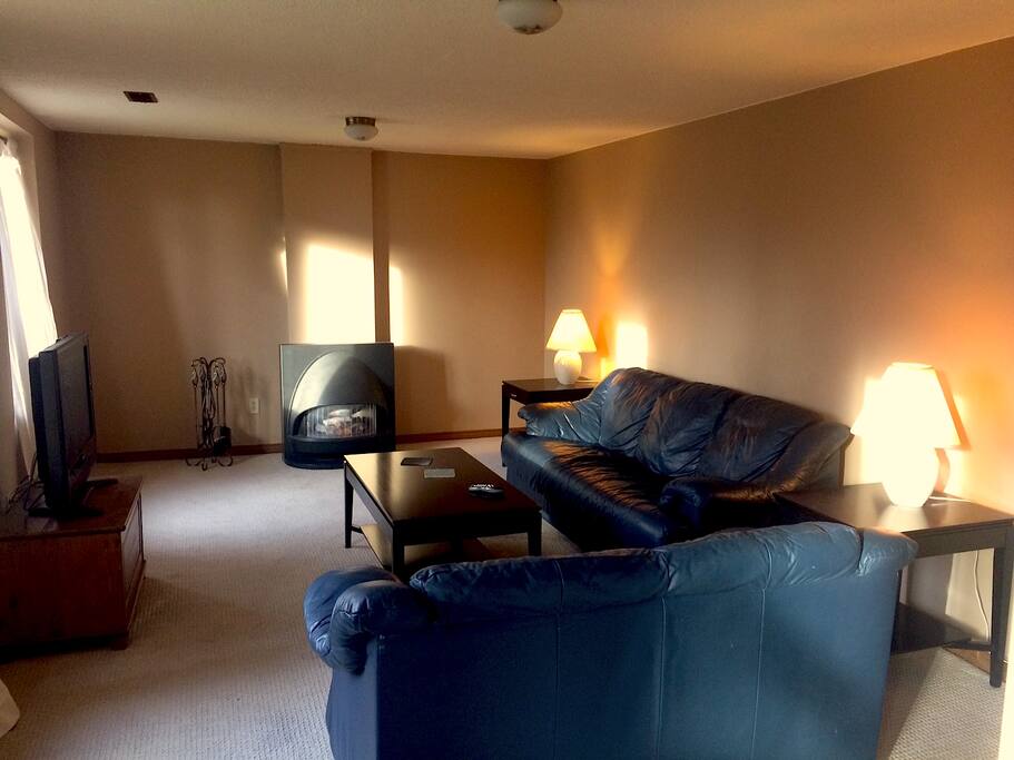 The spacious and bright living room from the side of the kitchen