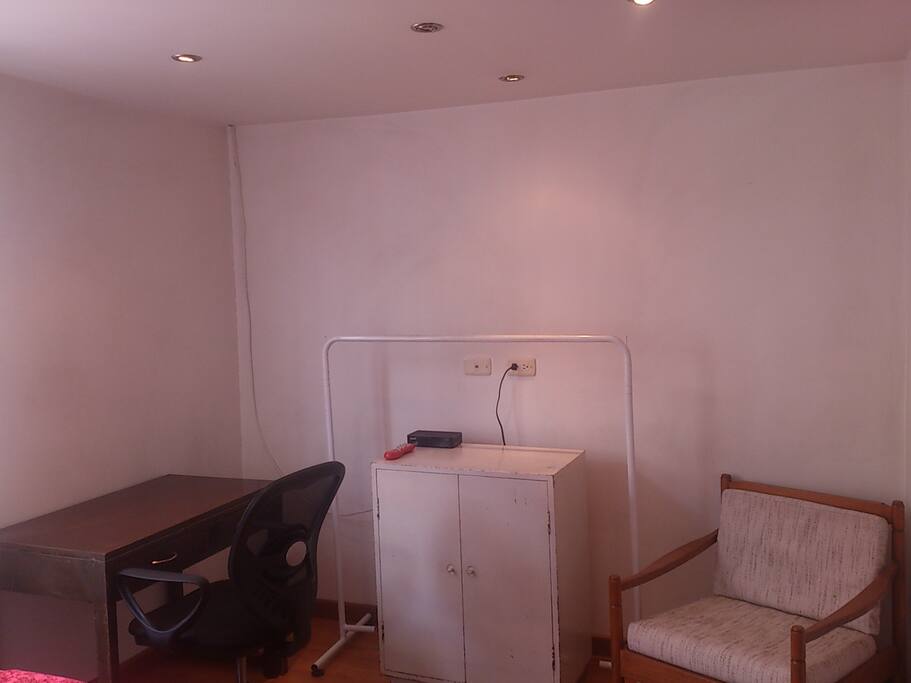 Escritorio, silla, sillon y mueble para guardar ropa.