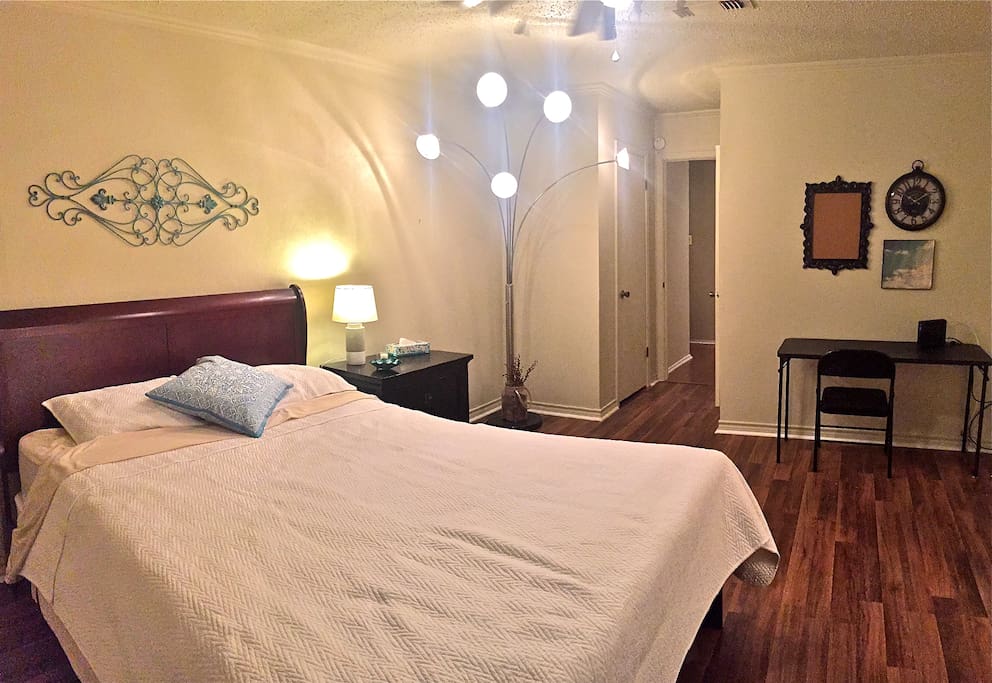 Updated Picture of master bedroom with new floors and brand-new bed. there are some sunlight resistant shutters that are great for after a night shift if you are in need of daytime sleep. Walls are actually more of a whiter color, something happened to the lighting I think