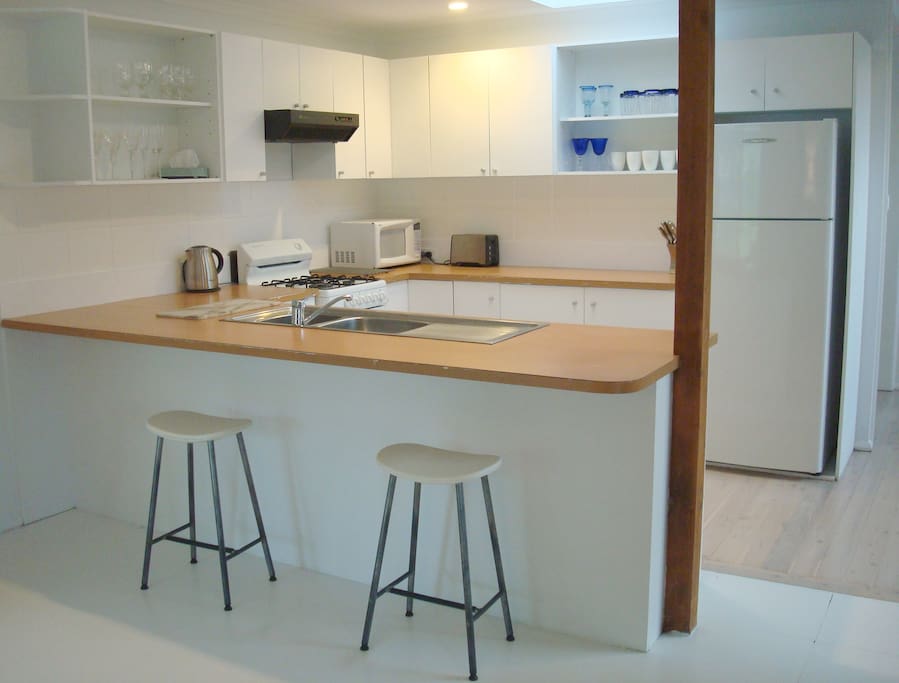 Functional well equipped U-shaped kitchen open to living and dining areas