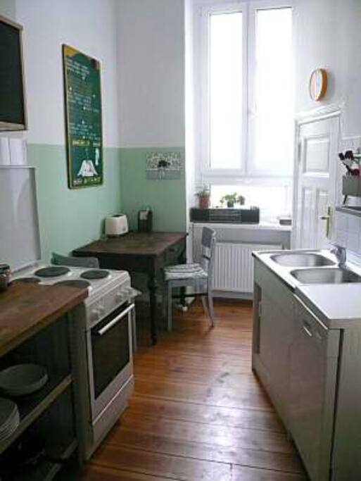 Kitchen with microwave, dishwasher, oven, washing machine and space for dining