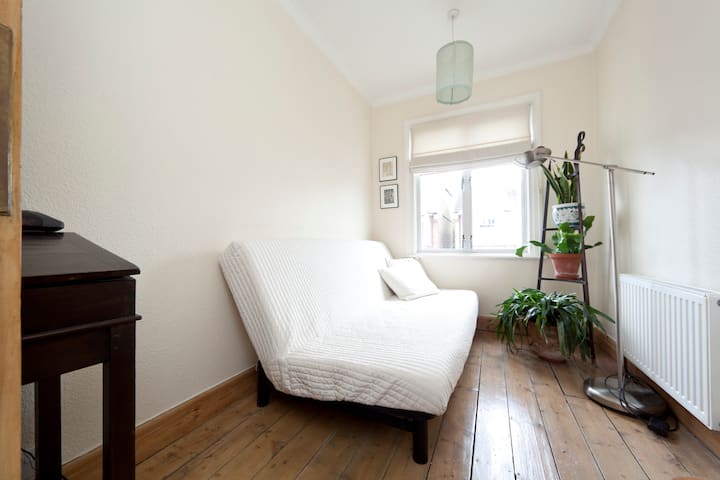 Upstairs small front room. Double bed (here shown folded as couch, but will be made up as a bed). Size 140 cm by 200cm or about 55 in by 79 in.