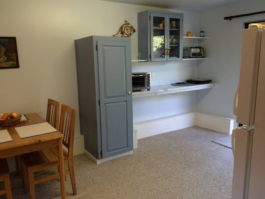 Kitchen left side with pantry and appliances.