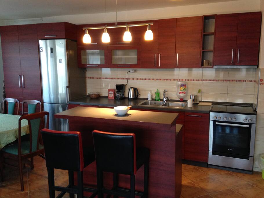 Enjoy breakfast at the breakfast bar/island. Newly renovated, completely stocked kitchen with ceramic cooktop stove (cooker) and full size oven. Full size refrigerator/ Dining room table seats six.