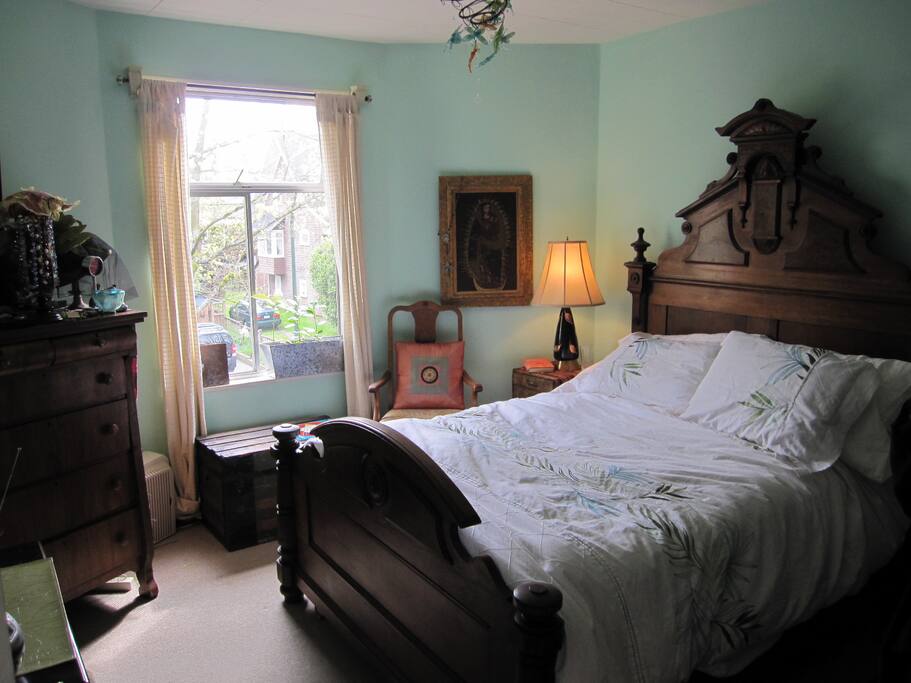 Peaceful sleep on this 150 year old antique bed. South Facing windows onto tree street view.
