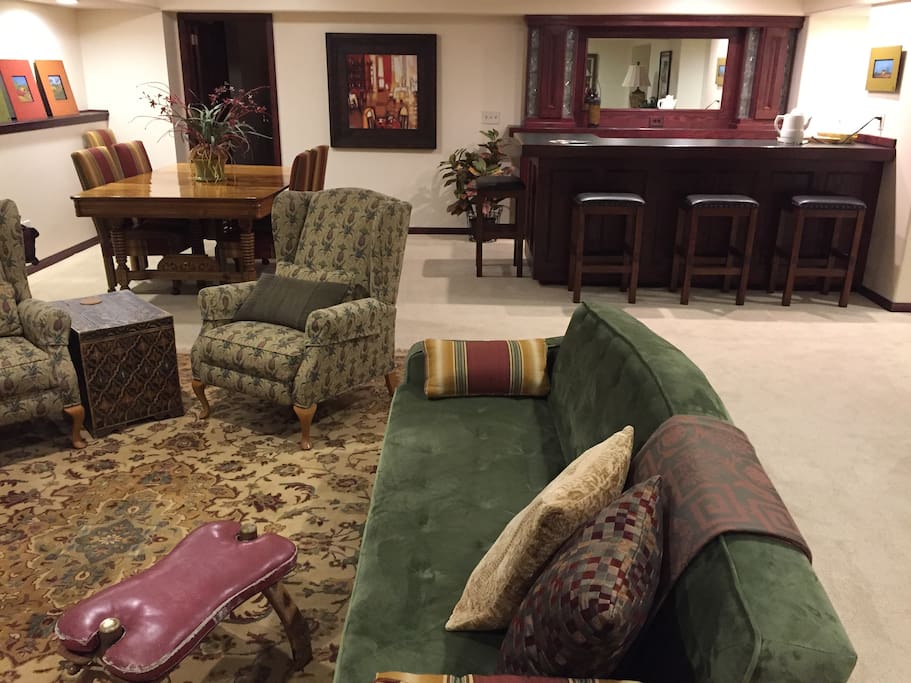 Living space with dining area and bar and door to bedroom.