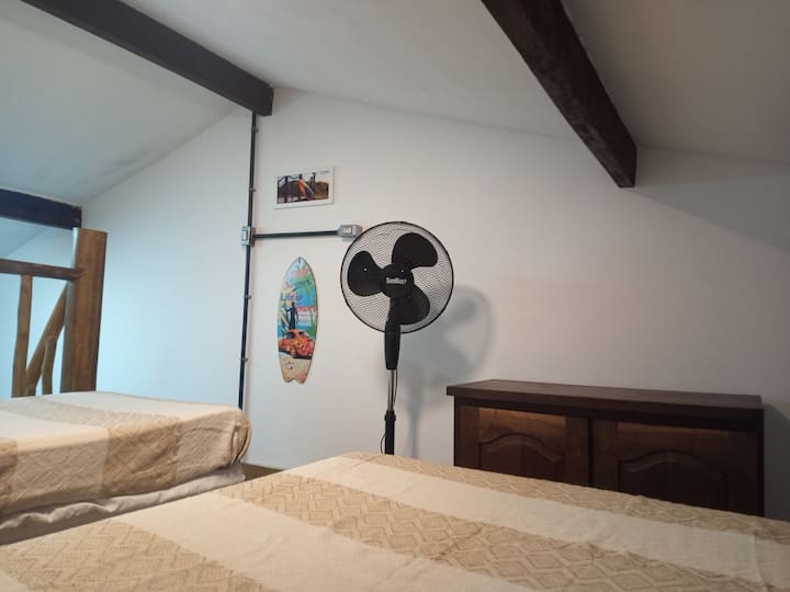 Ang Mesanino ay may 1 double bed, 1 single bed, fan at 1 dresser.