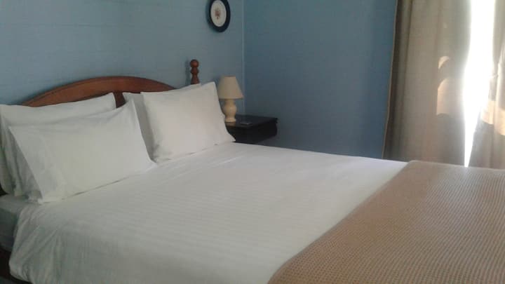 The separate bedroom in calming tones ensures peaceful nights on a comfortable pillowtop Queen bed.
