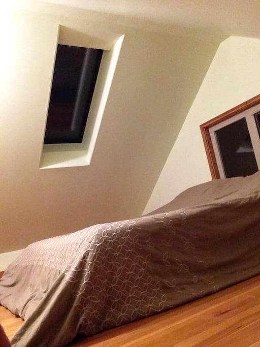 Upstairs Bedroom Newly Refinished. Clean comfortable and bright. Hardwood floors. Skylight. Double Bed.