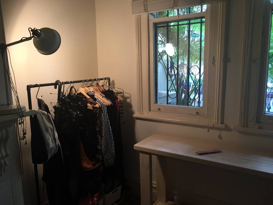 Writing desk overlooking leafy street.