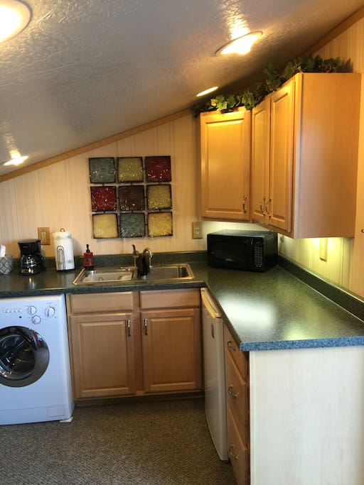 Kitchenette, showing sink area, countertop and washer/dryer