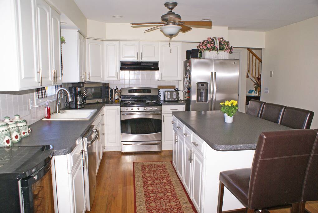 Stainless kitchen with large, five chair island.