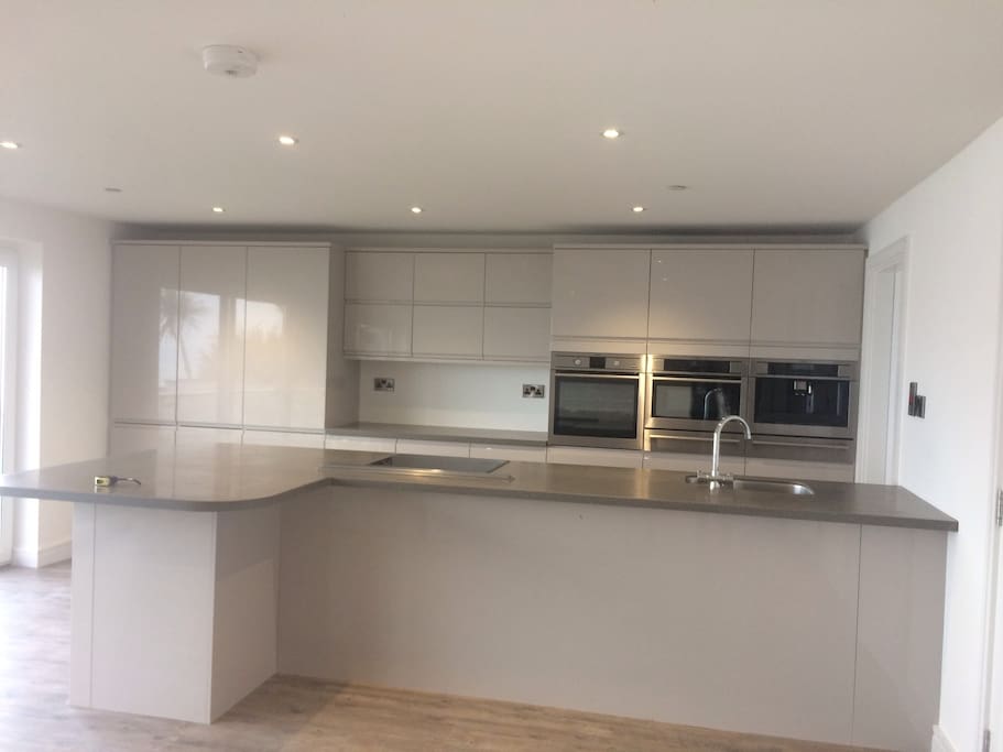 Open plan kitchen with dishwasher,microwave and coffee machine.