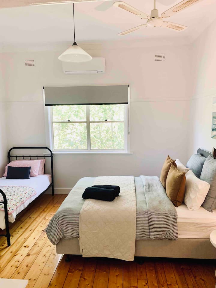 Bedroom 2 with a queen size bed and separate standard single bed.  Excellent quality linen provided.  Reverse cycle air conditioning, fan and built in wardrobes. 