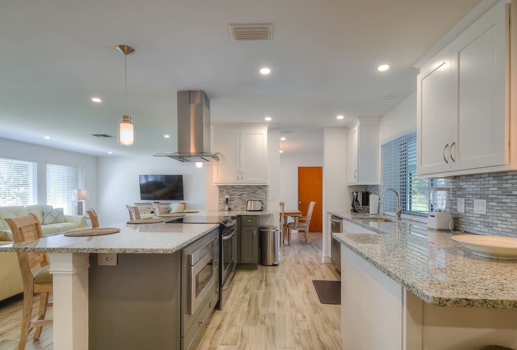 The kitchen features granite counters and stainless steel appliances