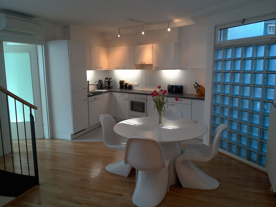 Modern dining and kitchen area, the stairs to the left lead to the private rooftop terrace