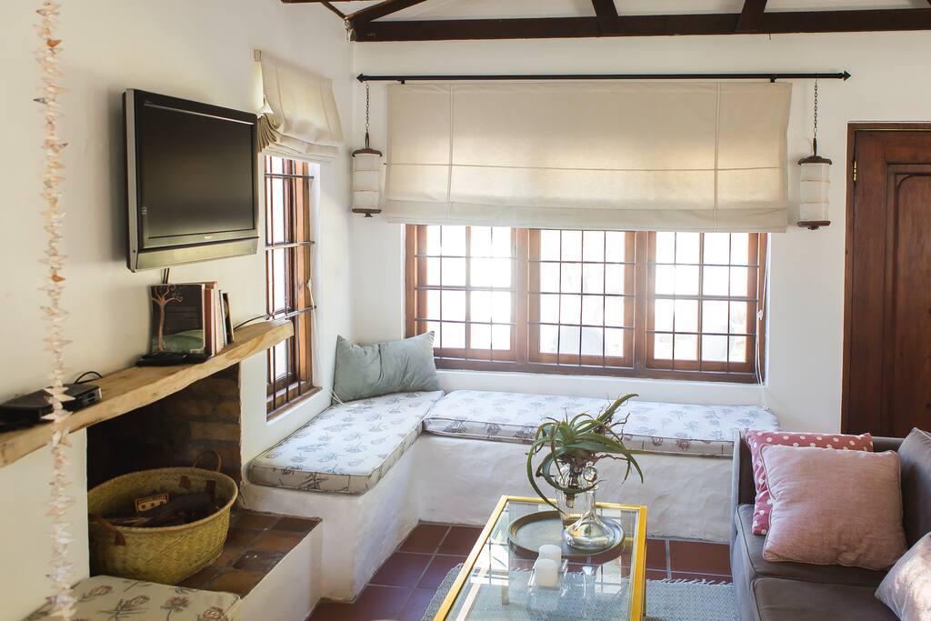 The Living area with TV, fireplace (wood provided) and lots of interesting books available to our guests.