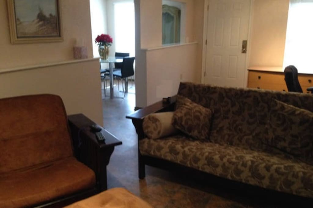 Living room both couch and chair are futons and convert to a double bed and twin.