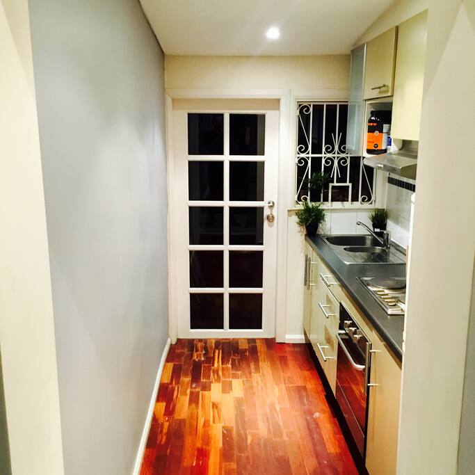 Modern kitchen with everything you need to cook up a storm! Opening up to a private courtyard to enjoy a morning coffee.