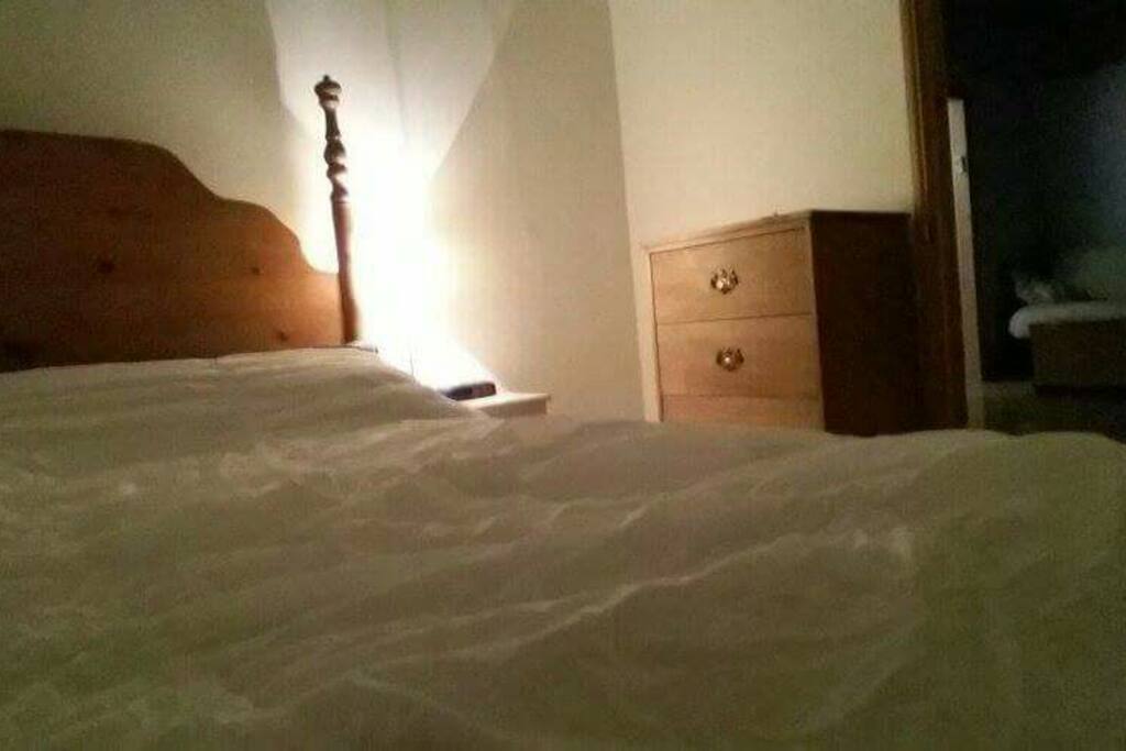 Bedroom#1 at night: brand new queen memory foam mattress and wooden dresser