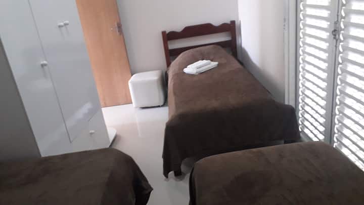 Bedroom with three single beds. 