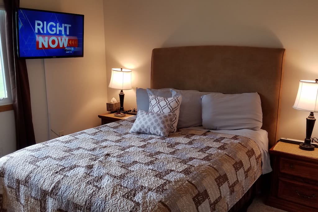 Select comfort queen bed, 40" TV w/DirectTV, ceiling fan, 2 end tables each with a power strip.