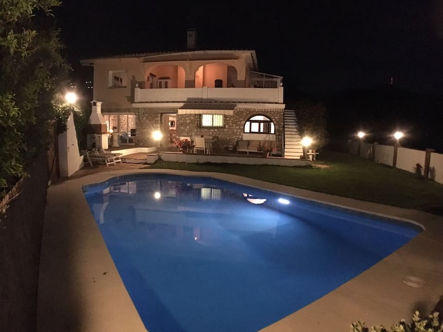 Villa Casa Ladera at night with lighted pool and garden