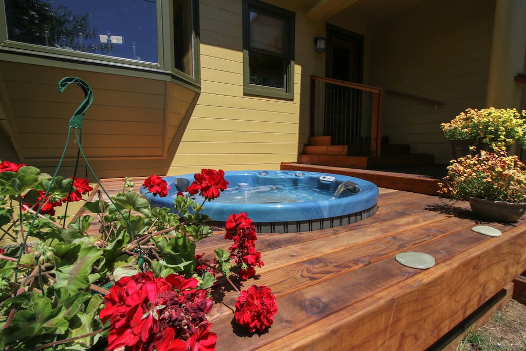 Take a long soak in the sunny, private hot tub at Greentree Cottage!