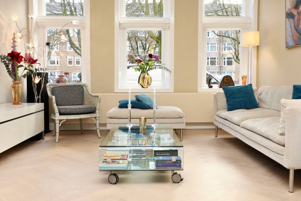 Large bright living room with electric fireplace and open kitchen