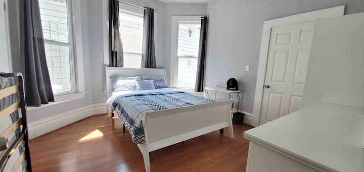 2F - 1st bedroom with queen bed, folding bed, closets, small table and chair. 